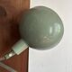 Old extendable accordion lamp in celadon green, workshop spirit.