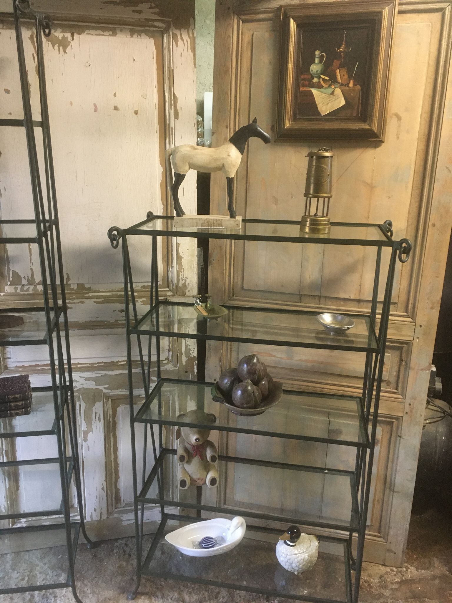 Pair of wrought iron and glass bookshelf shelves.