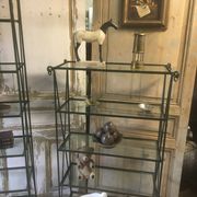 Pair of wrought iron and glass bookshelf shelves.