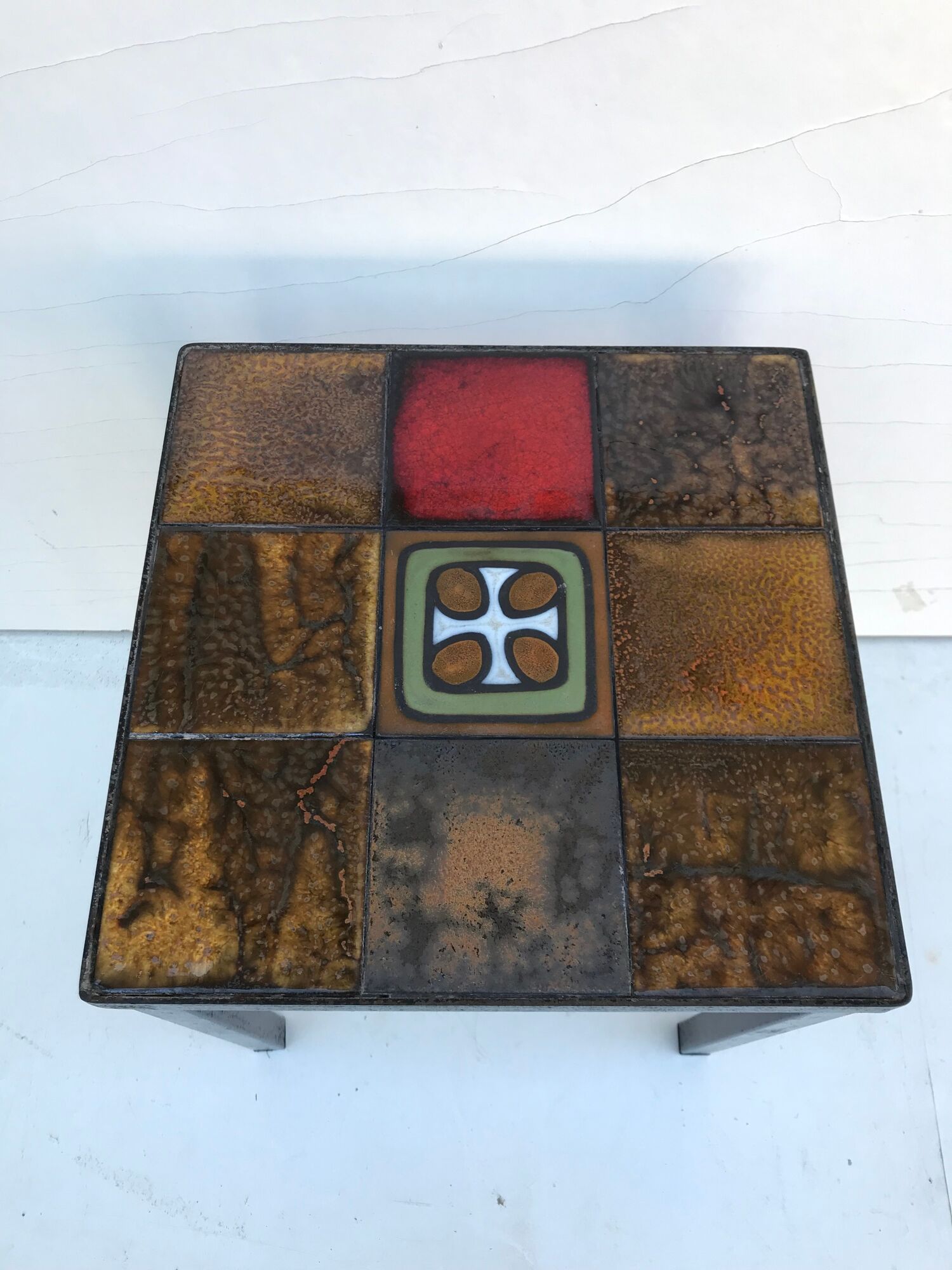 Old black metal and majolica tiles table