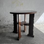 Dark brown solid wood Brutalist round side table, circa 1970, sculptural