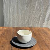 White Indonesian ceramic cup and gray saucer