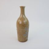 Brown ceramic/stoneware bottle with chiseled floral pattern