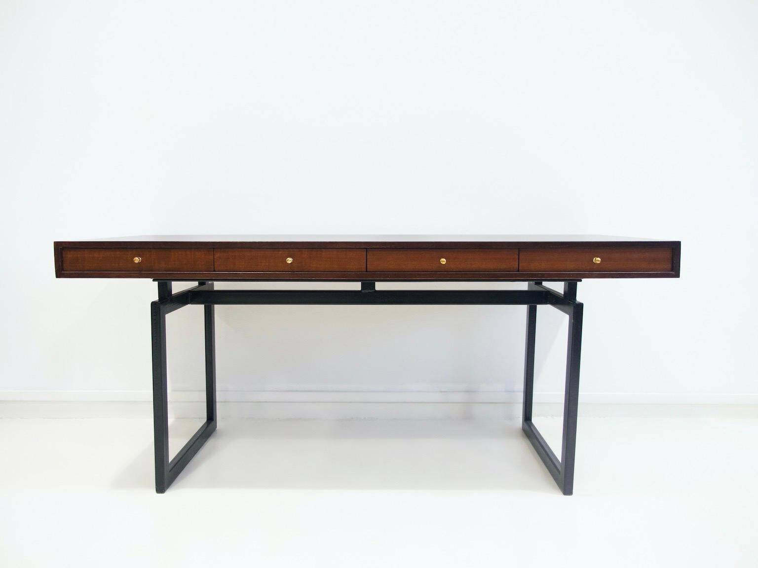 Wooden desk with drawers and black lacquered legs.