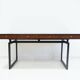 Wooden desk with drawers and black lacquered legs.