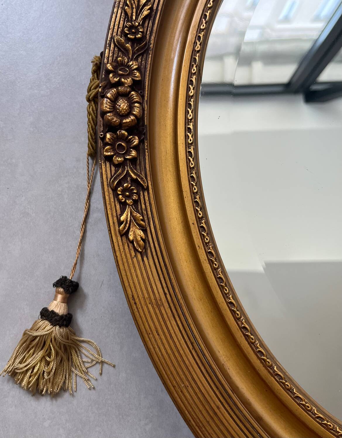 Oval gilt mirror and Art Deco trim