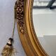 Oval gilt mirror and Art Deco trim