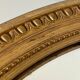 Oval mirror in carved wood, stuccoed and gilded with leaf Louis XVI style late nineteenth century