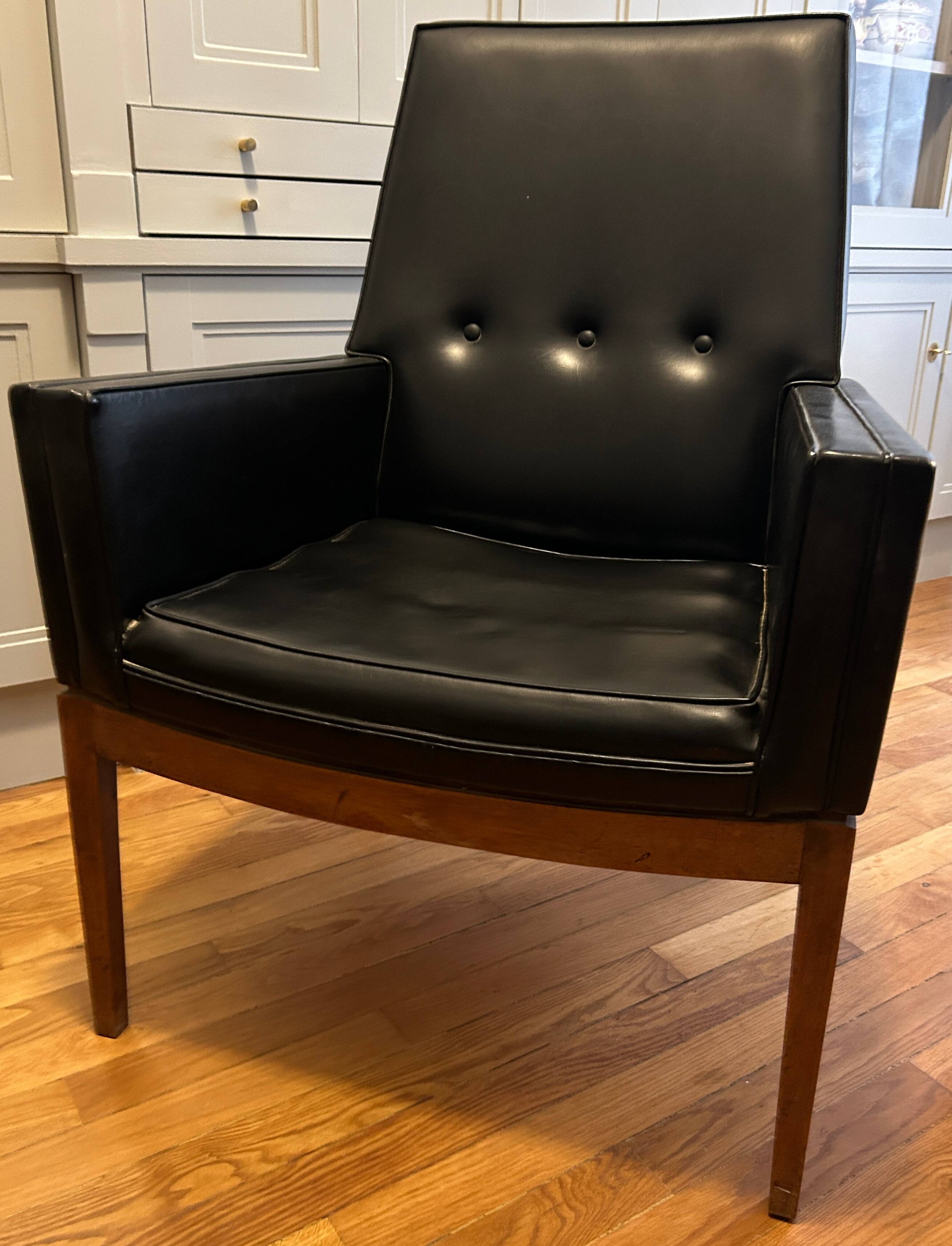 Modernist armchair in wood and black synthetic leather, circa 1960