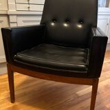 Modernist armchair in wood and black synthetic leather, circa 1960
