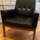 Modernist armchair in wood and black synthetic leather, circa 1960