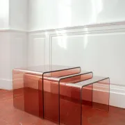 Vintage trio of nesting tables in smoked plexiglass by Michel Dumas, year