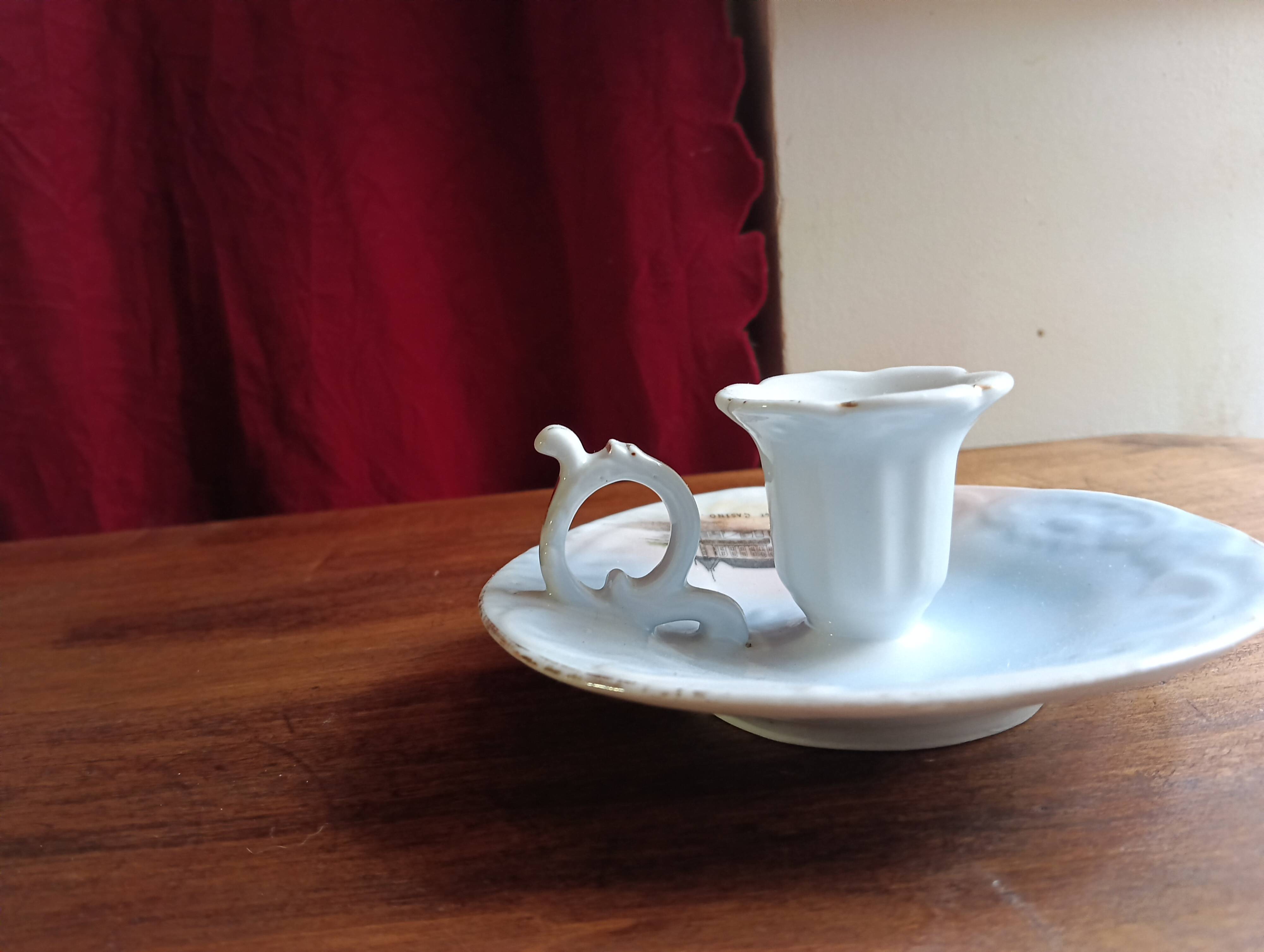 Antique handheld candle holder in porcelain
