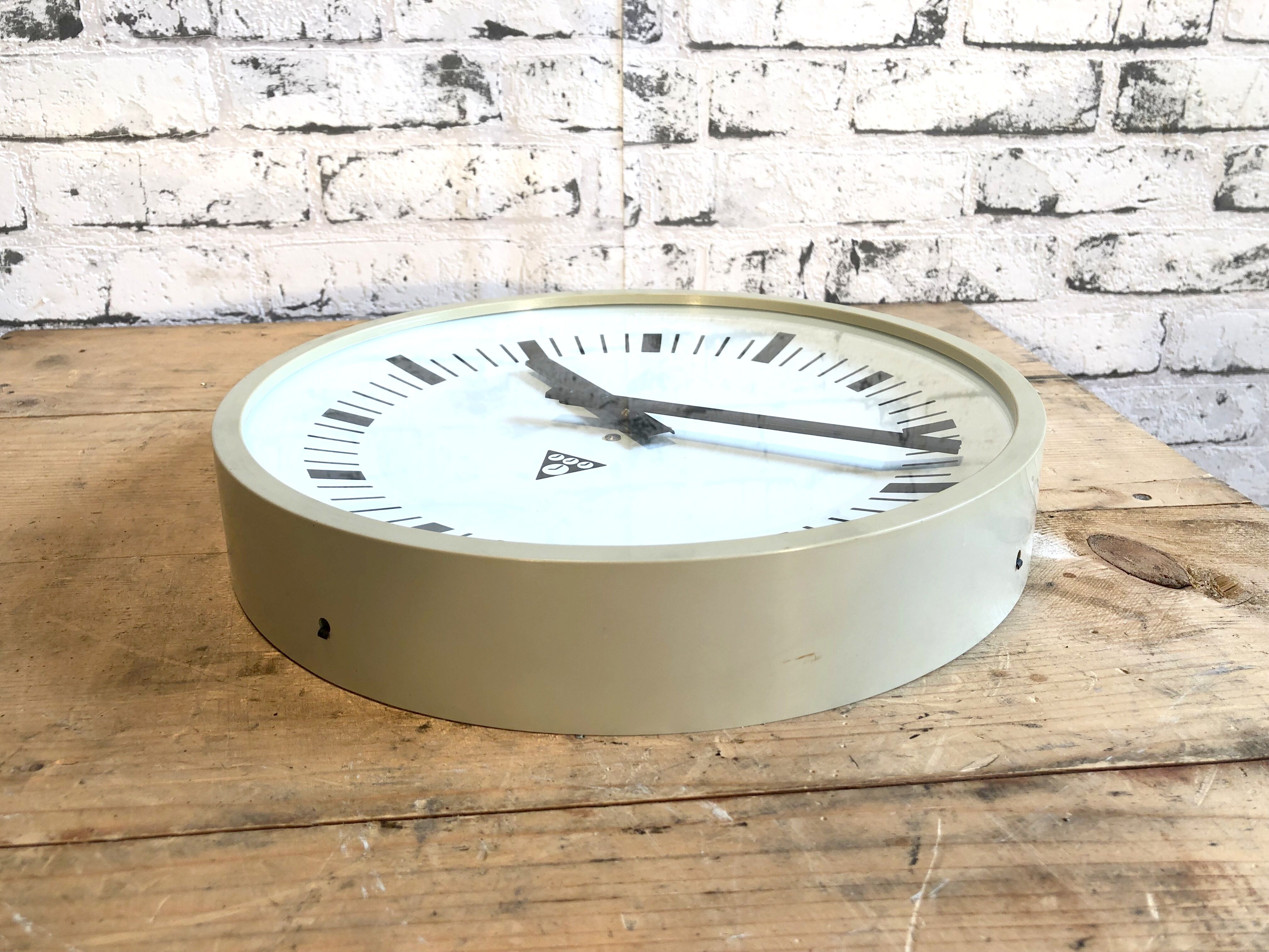 Beige industrial bakelite wall clock from Pragotron, 1970s