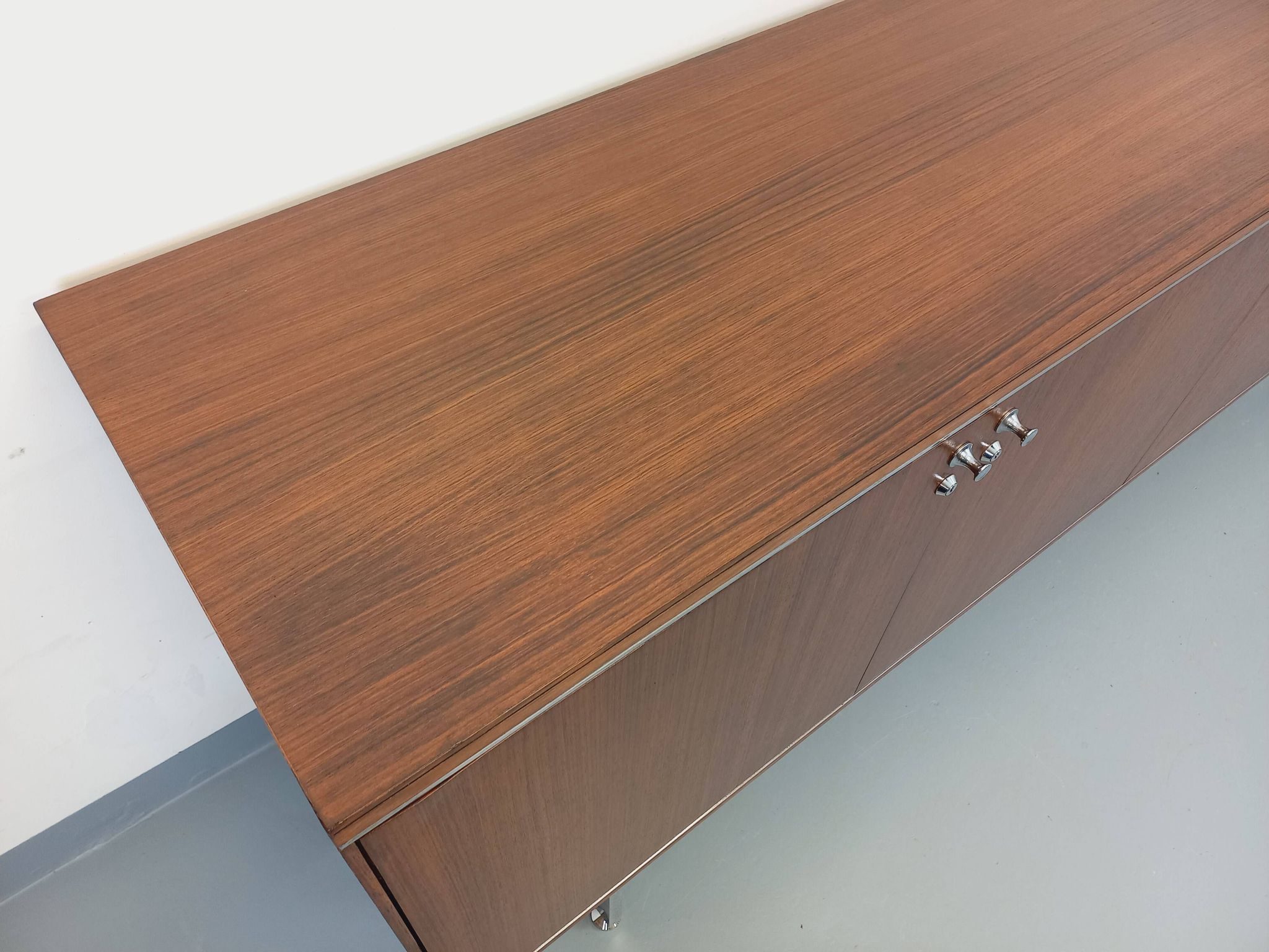 Vintage modernist enfilade in rosewood and chrome metal from the 60s and 70s.