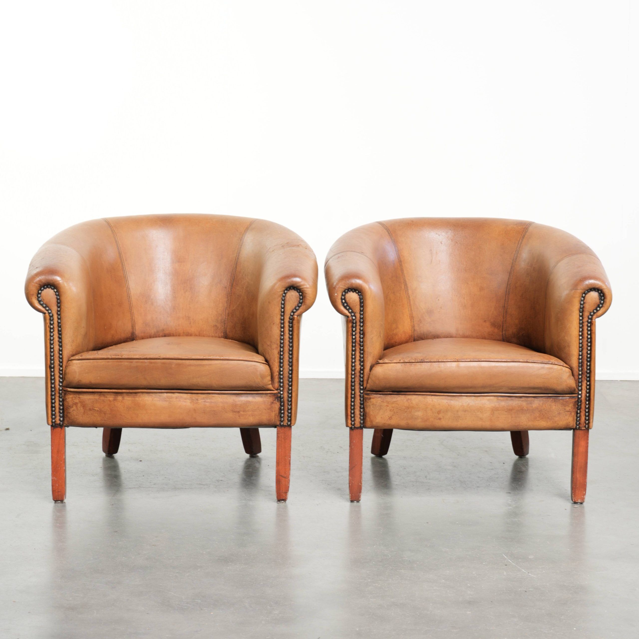 Set of two vintage sheepskin club armchairs with a beautiful light colour