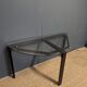 Black metal console with glass top