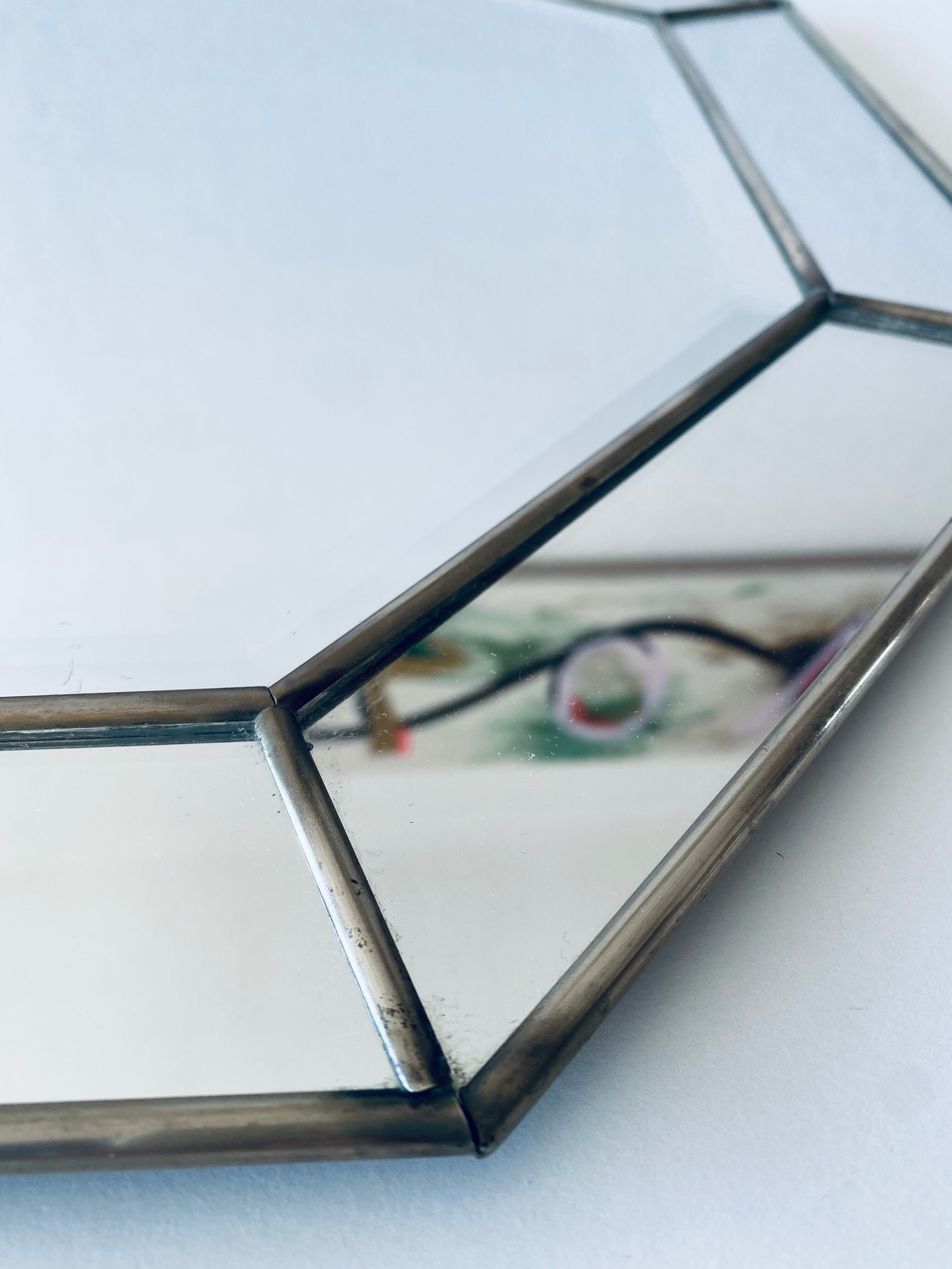 Old octagonal beveled mirror with parcloses