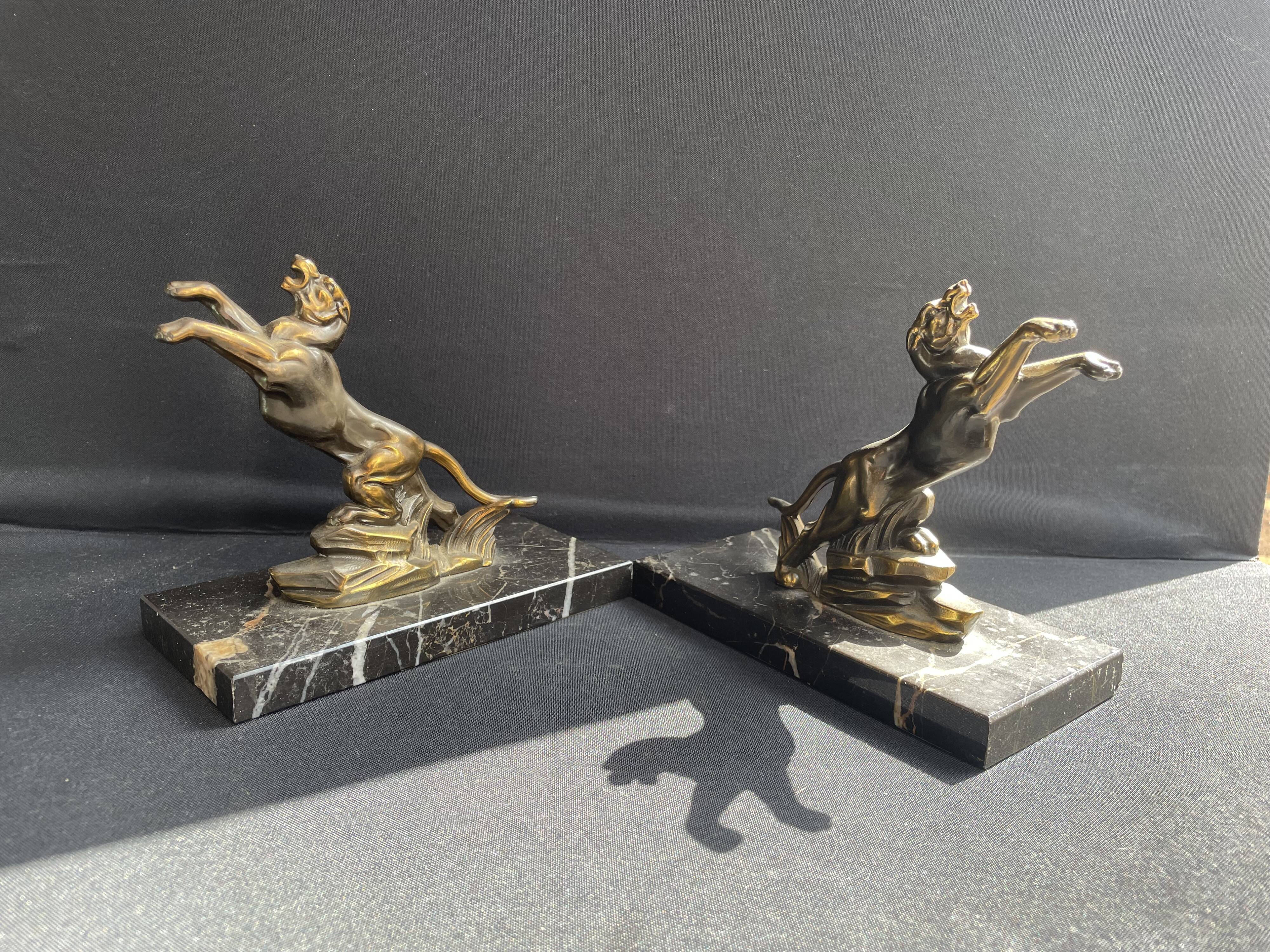 Pair of art deco marble and patinated regulated bookends