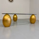 Vintage Italian design coffee table with a glass top and gold base, dating from the 1980s.