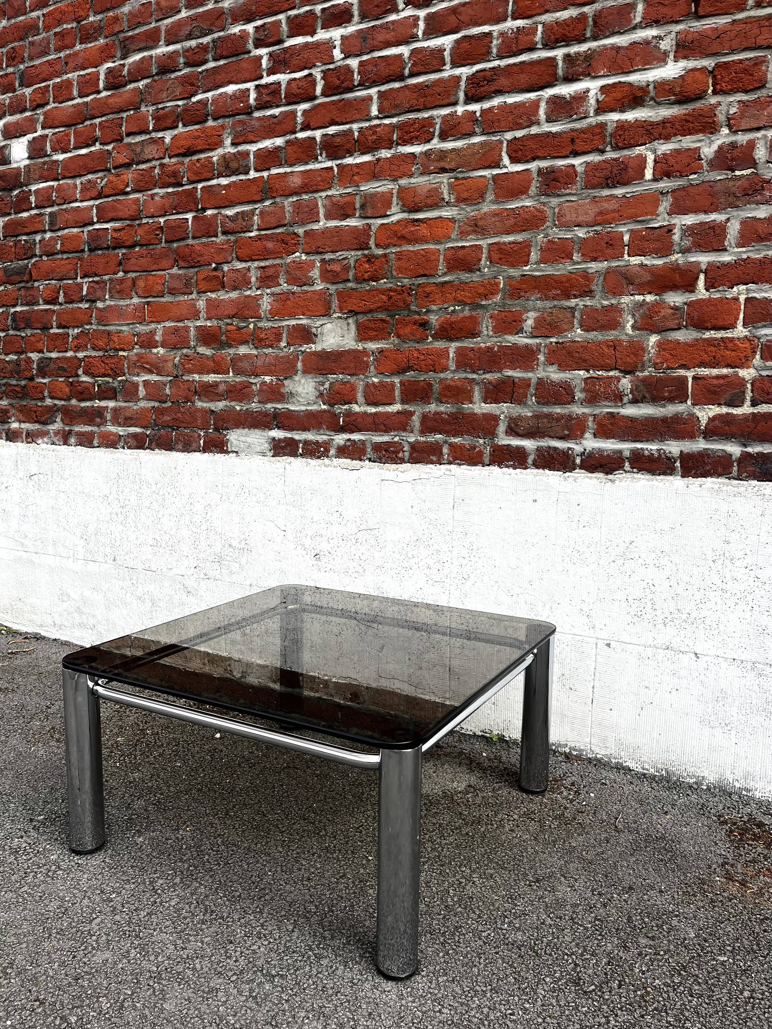 Vintage smoked glass coffee table with chrome structure.