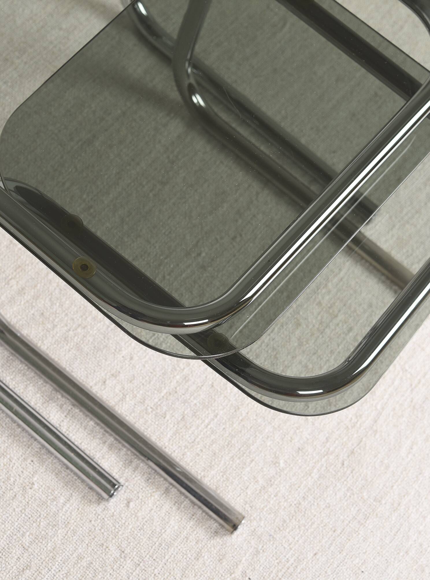 Pair of nesting tables in smoked glass and chrome legs.