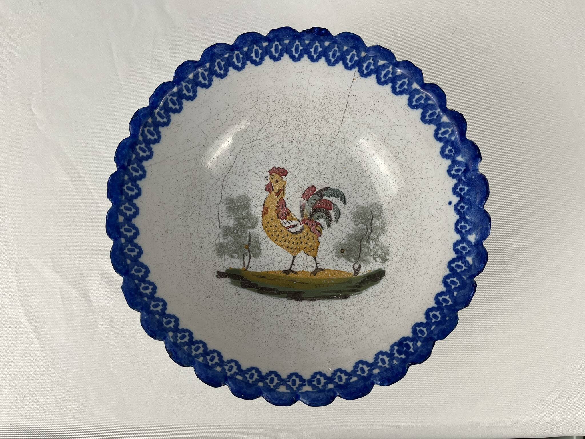 Regional earthenware small hollow dish decorated with 20th century rooster