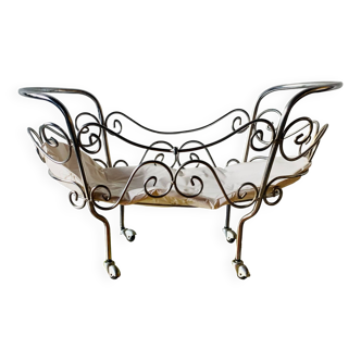 Metal doll's bed on vintage casters