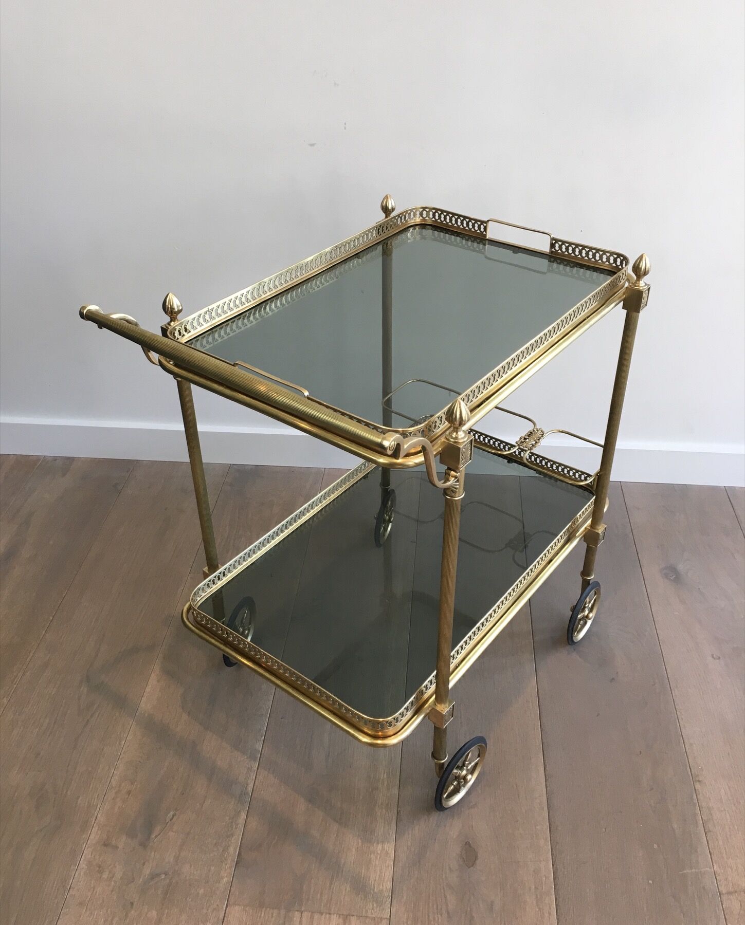 Neoclassical style rolling table in brass with blue glass tops
