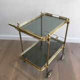 Neoclassical style rolling table in brass with blue glass tops
