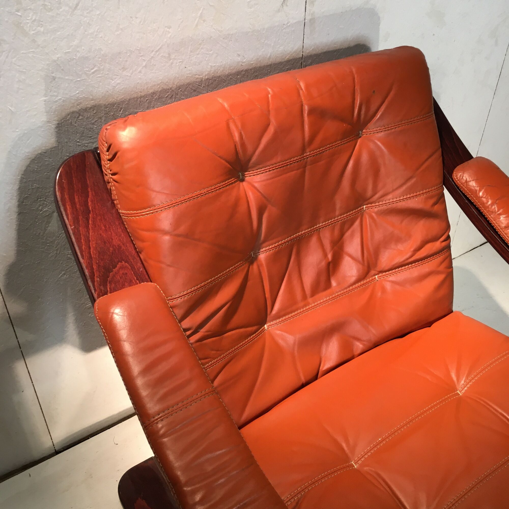 Duo of ochre leather and wood frame armchairs