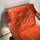 Duo of ochre leather and wood frame armchairs