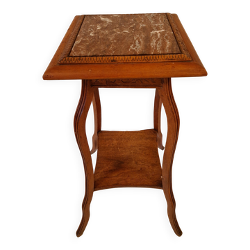 Antique Art Nouveau pedestal table with carved wood and marble top.