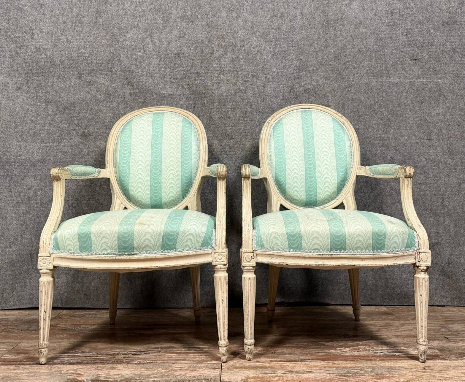 Pair of Louis XVI cabriolet armchairs in lacquered wood, 18th century