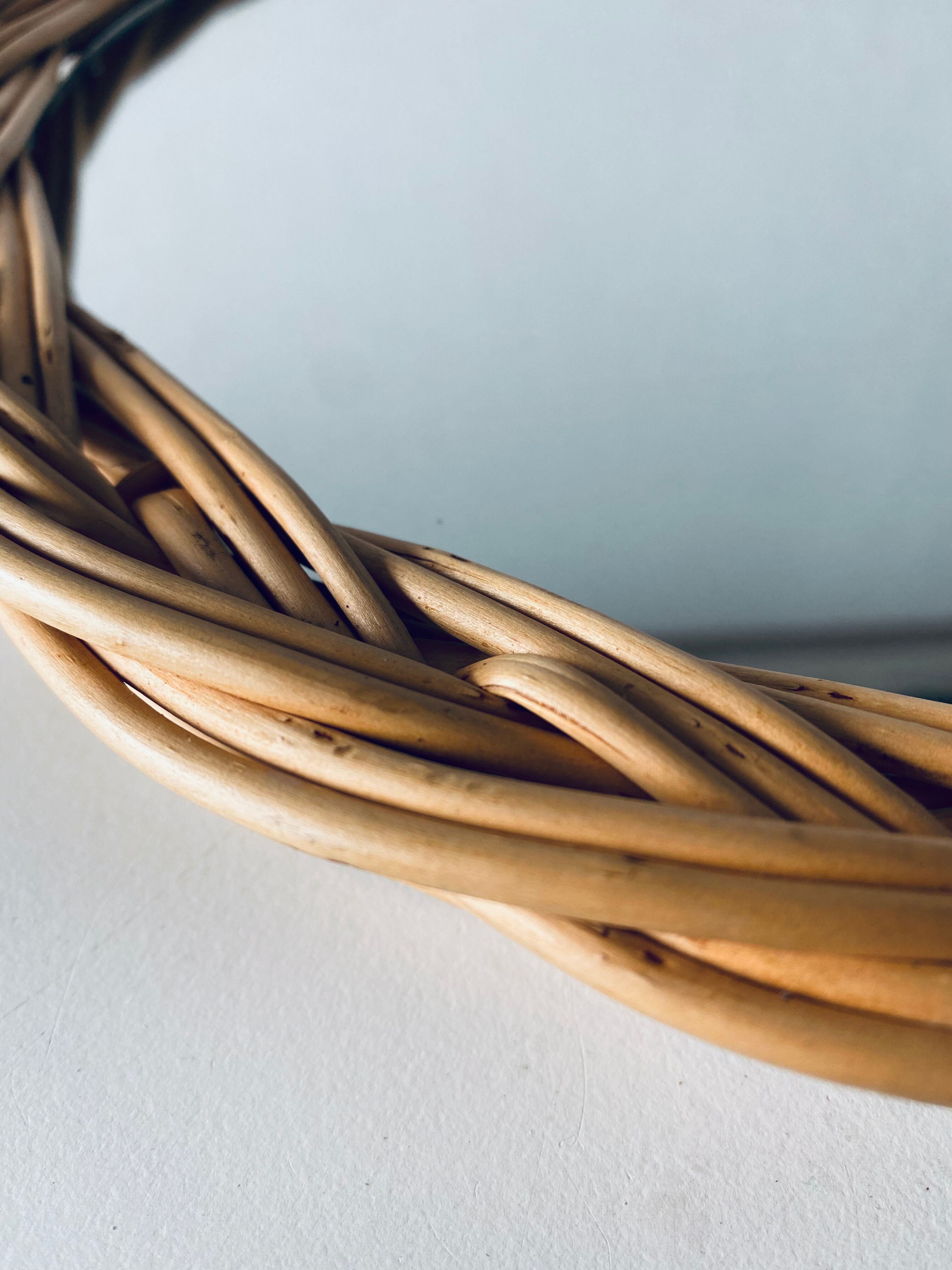 Round mirror in vintage wicker