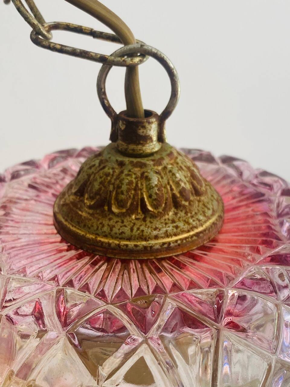Antique pink glass pendant light with tassels.