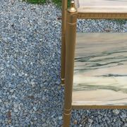 Pair of neoclassical side tables in bronze, brass, marble, and o.