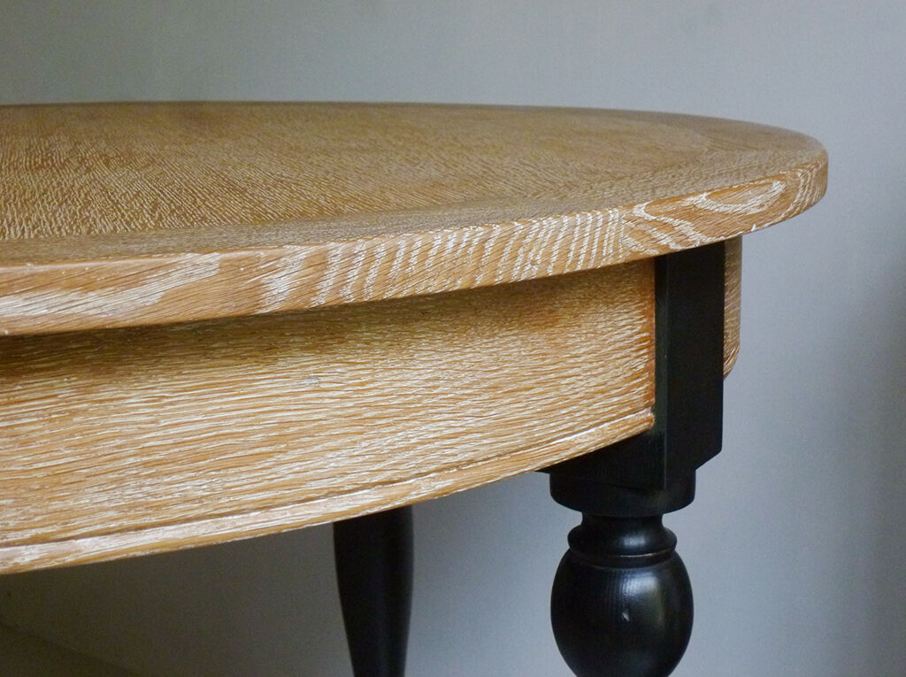 Round table in coloured cerused oak, waxed coloured feet