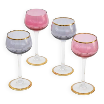 Four colorful stemmed wine glasses