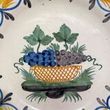 Faience dish of eighteenth-century style nevers decorated with basket with bunches of grapes