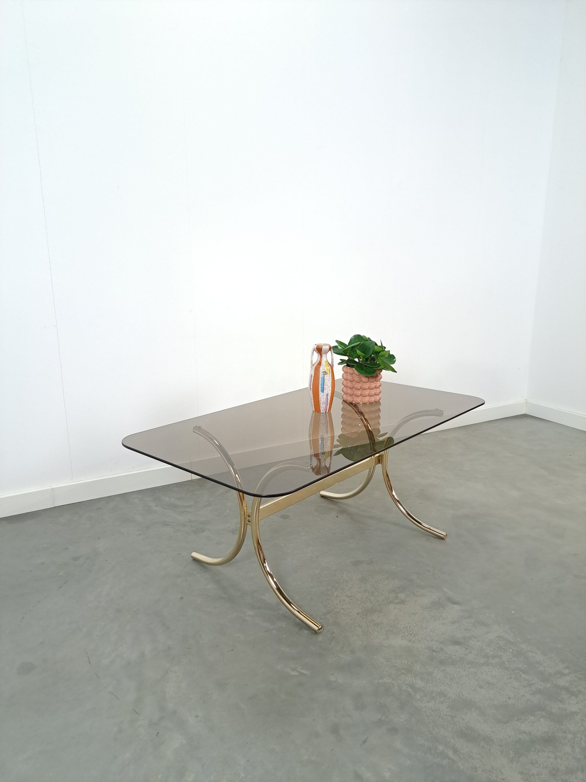 Smoked glass coffee table with gold-coloured legs from Sweden