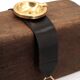 Golden metal armrest ashtray with faux leather and stirrups, 1950s.