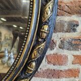 Ancien miroir ovale patiné noir et doré style louis xv