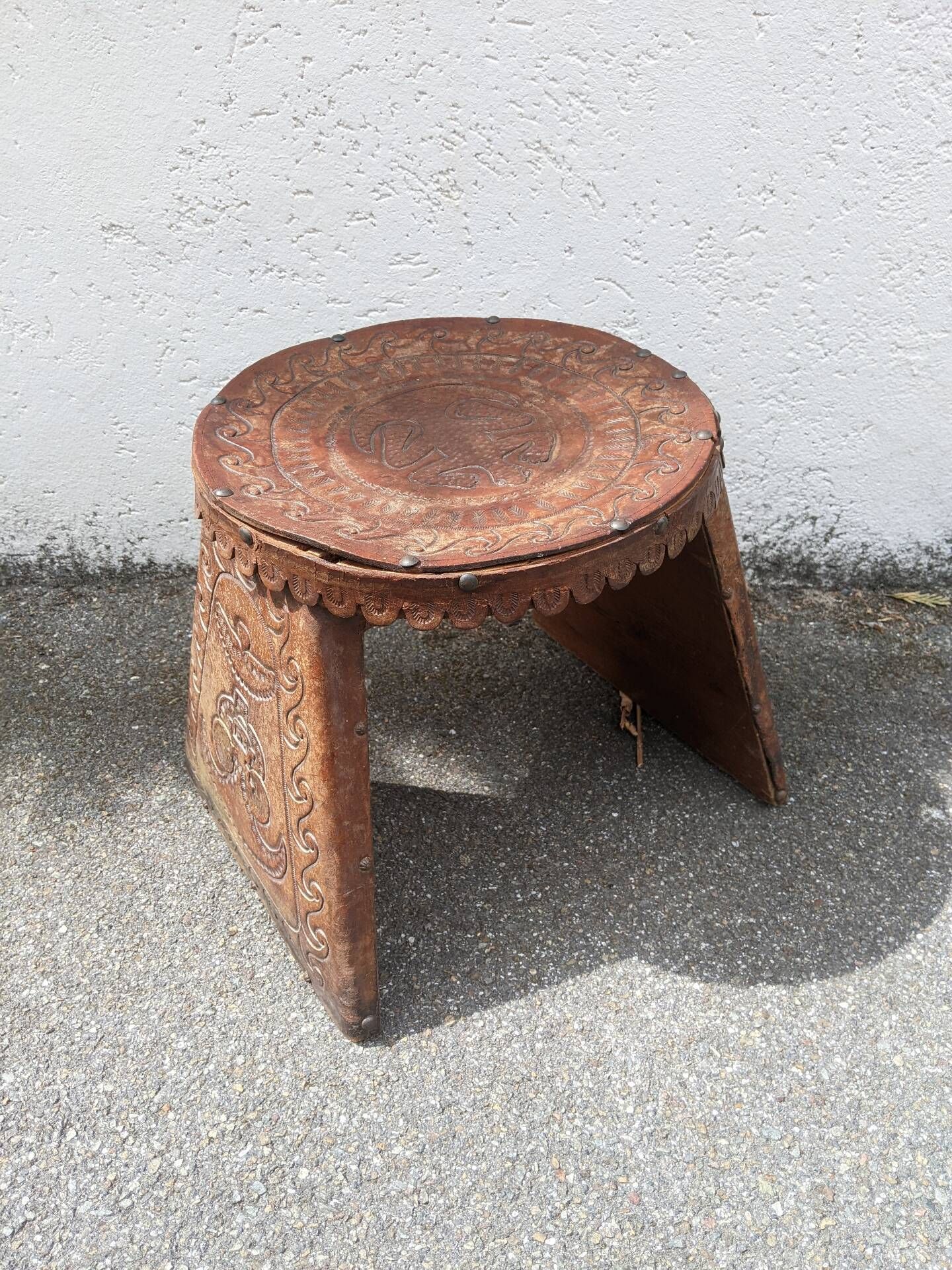 Wood and leather stool, handcrafted African art.