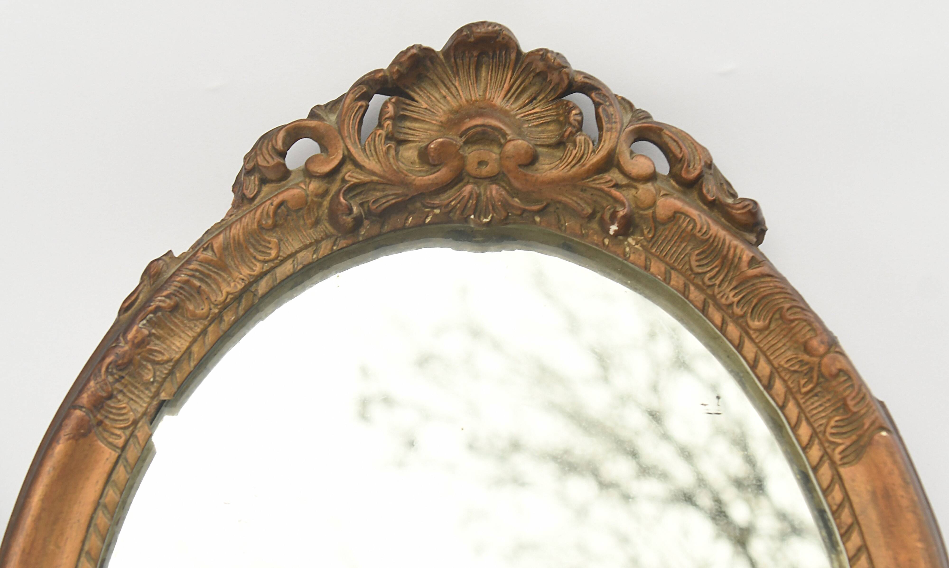 Pair of oval wooden windows with golden patina