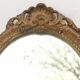 Pair of oval wooden windows with golden patina