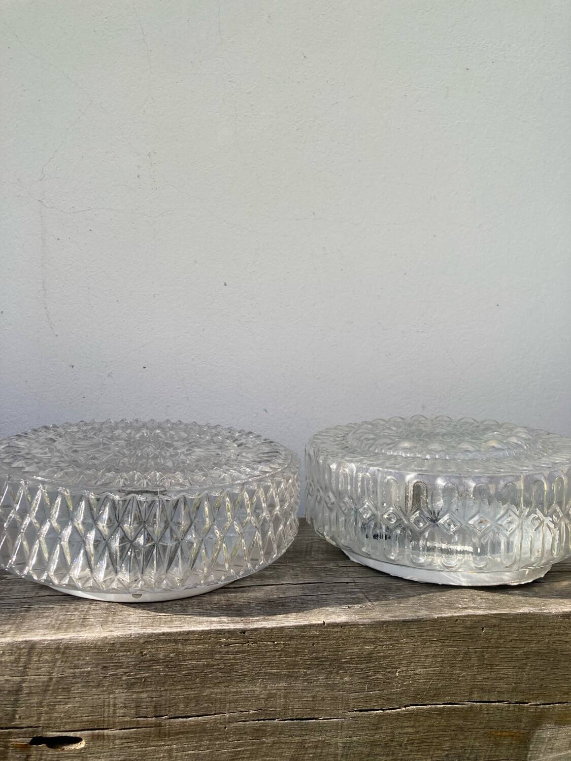 Pair of transparent round glass wall lights