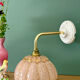 Vintage glass wall light with a pink and gold Clichy globe.