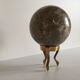 Marble ball paperweight on vintage brass