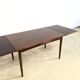 Rosewood dining table with integrated extensions — Denmark, 1960s